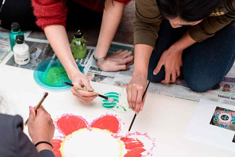 Three individuals painting together