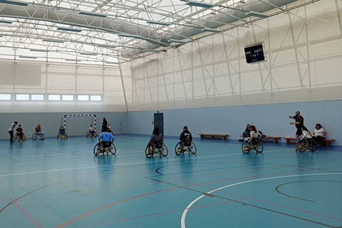 Wheelchair users playing sport in sports hall