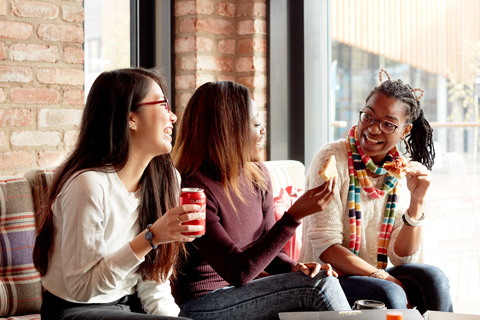 Students eating pizza in dining hall