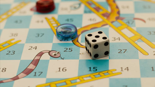 Close-up of snakes and ladders board game.