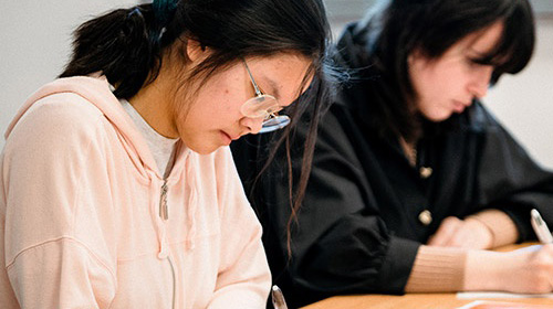 Students writing on worksheets