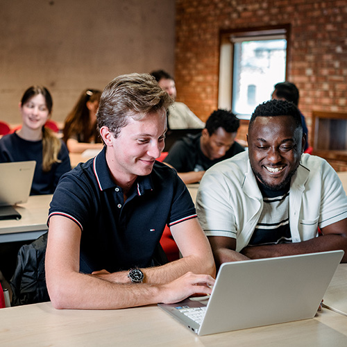 Events, hospitality and tourism students in seminar working at laptop