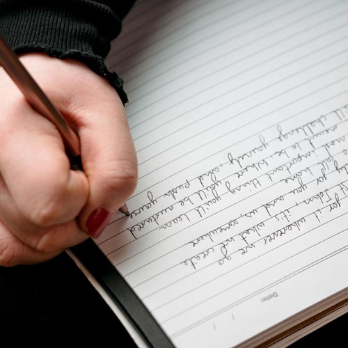 Close up of writing notes on lined paper