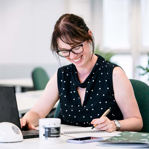 Person working at a laptop at desk in the Enterprise Centre