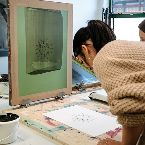 Student working on graphic design artwork