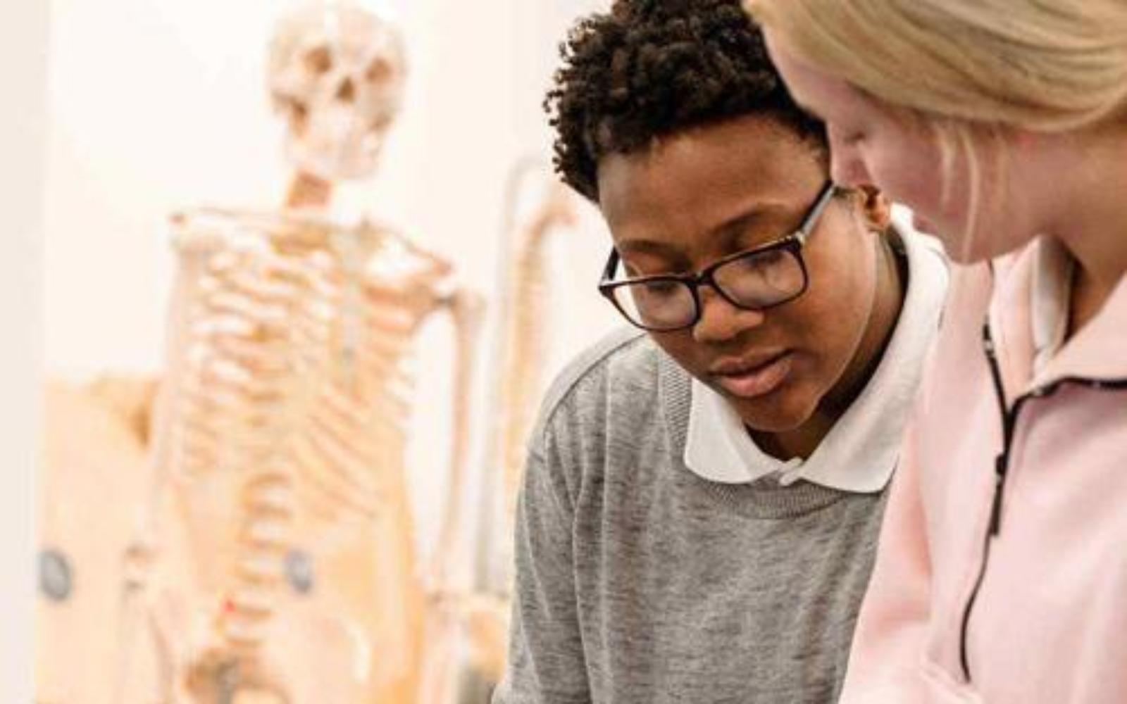 Two health students working together on an examination