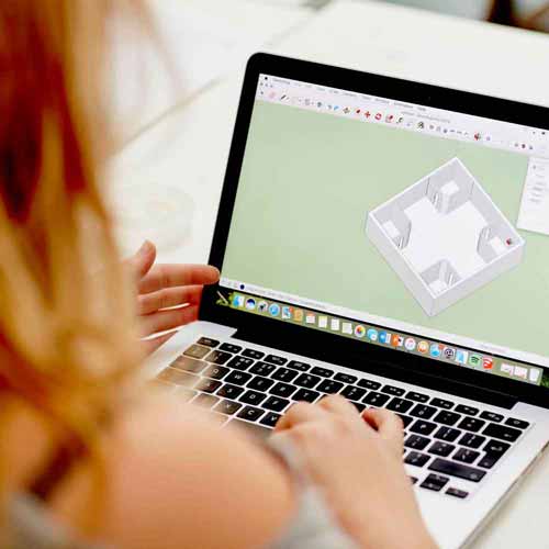 Student using design software on laptop