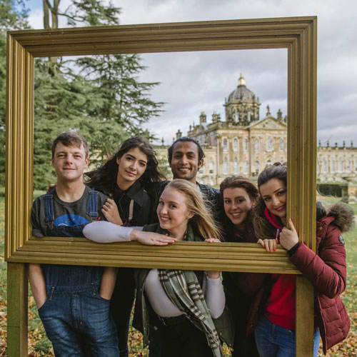 Group of happy students taking a picture at Castle Howard