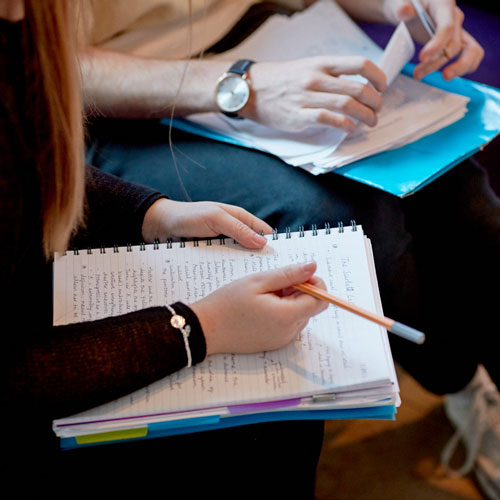 Two students studying and taking notes