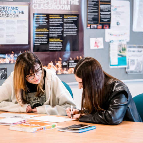 Two students in discussion during Japanese class