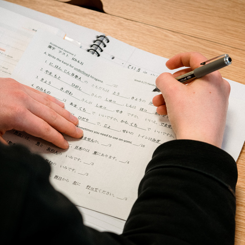 Student completing worksheet during Japanese class