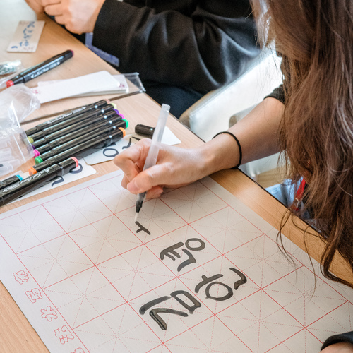 Student practising Korean calligraphy