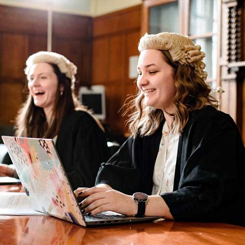 Students wearing barrister's wigs in mock court room