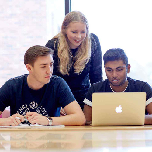 Students and lecturer chat during a business tutorial.