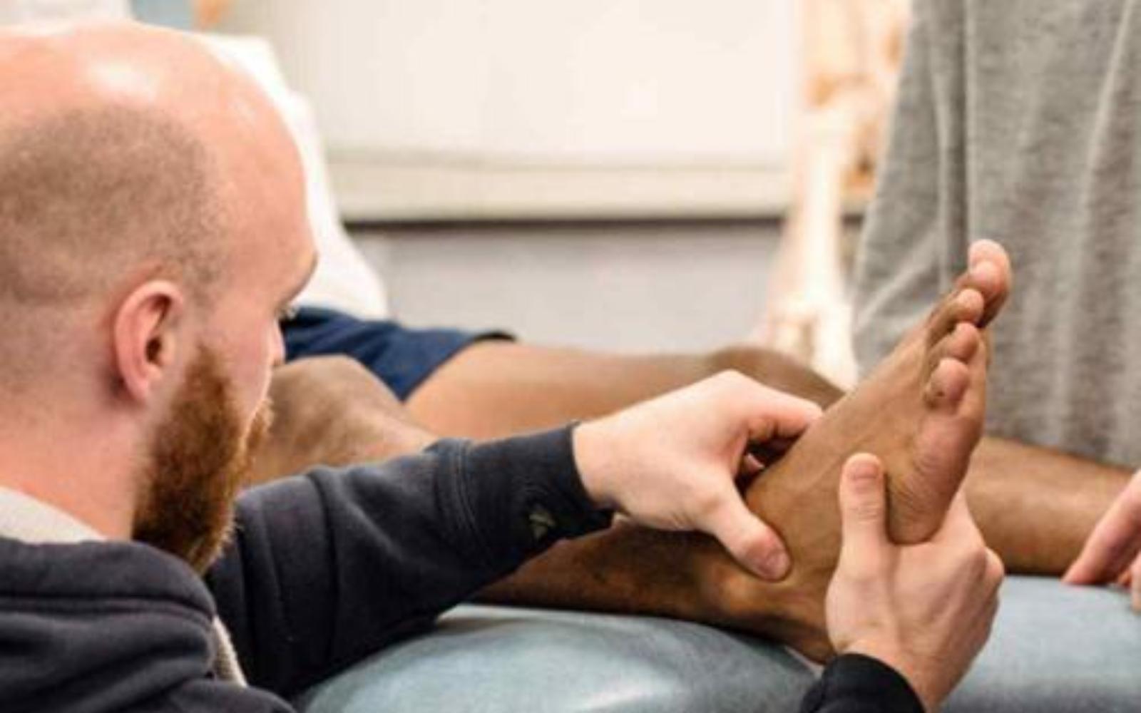 Health student examining foot