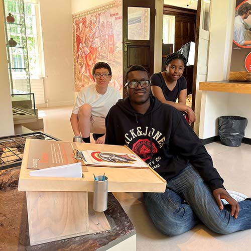 Group in house next to art desk