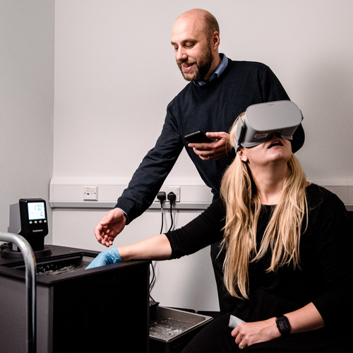 Staff member and student using VR psychology equipment