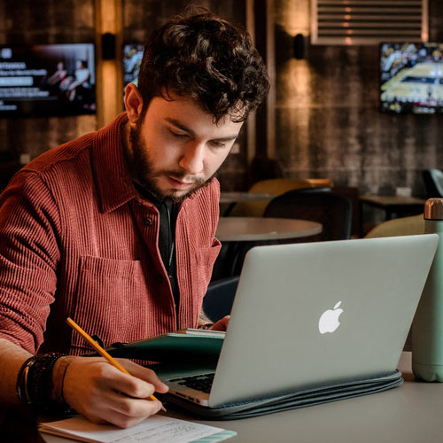 A student works at a laptop.