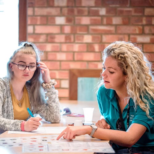 Student Ambassador talking to school student during workshop