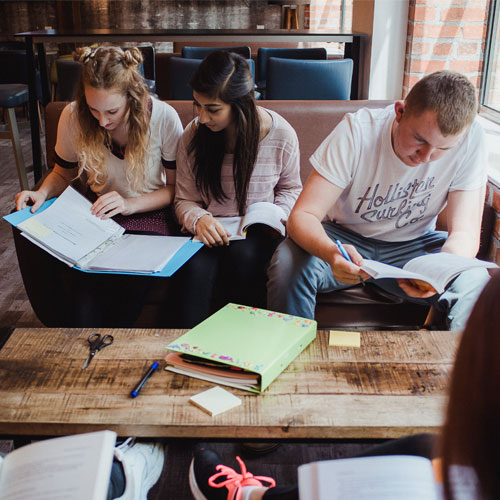 3 students working at a coffee table in the Students' Union