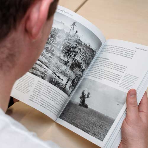 Student reading book about war