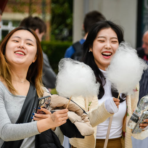 Two students with candyfloss during Welcome Week.