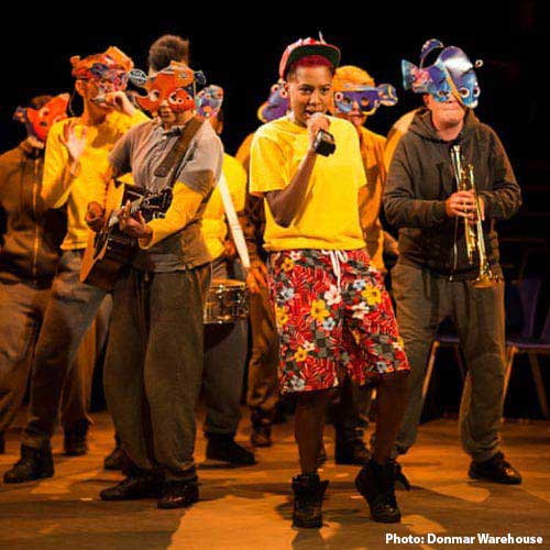 Group of performers, one with microphone