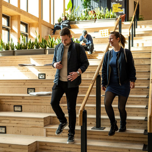 Two students walking in the Creative Centre on campus.