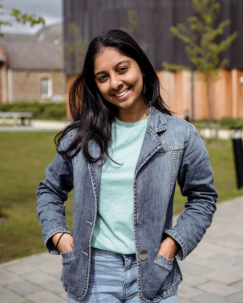 York St John student standing in front of Creative Centre smiling