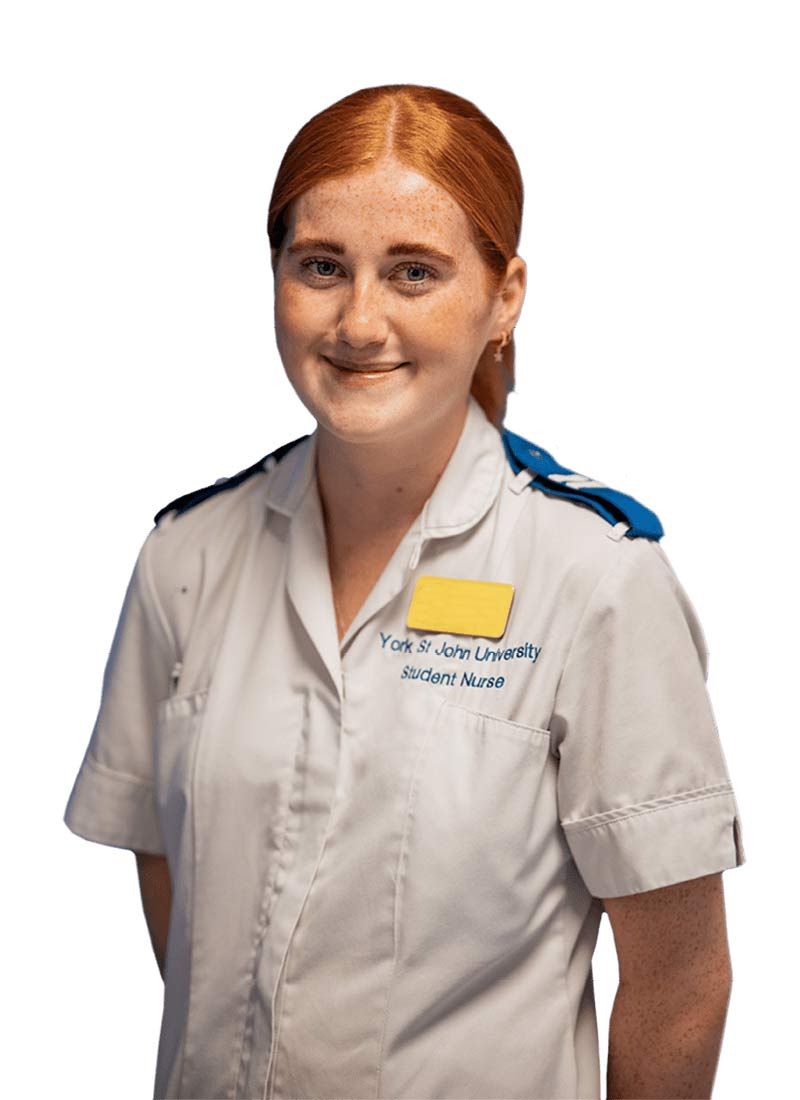 Female nursing student wearing the uniform and smiling at the camera