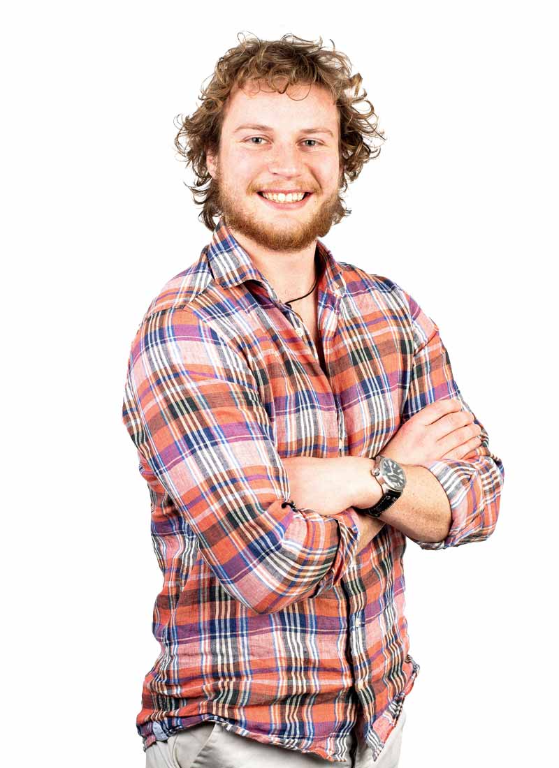 Male student in check shirt smiling to camera