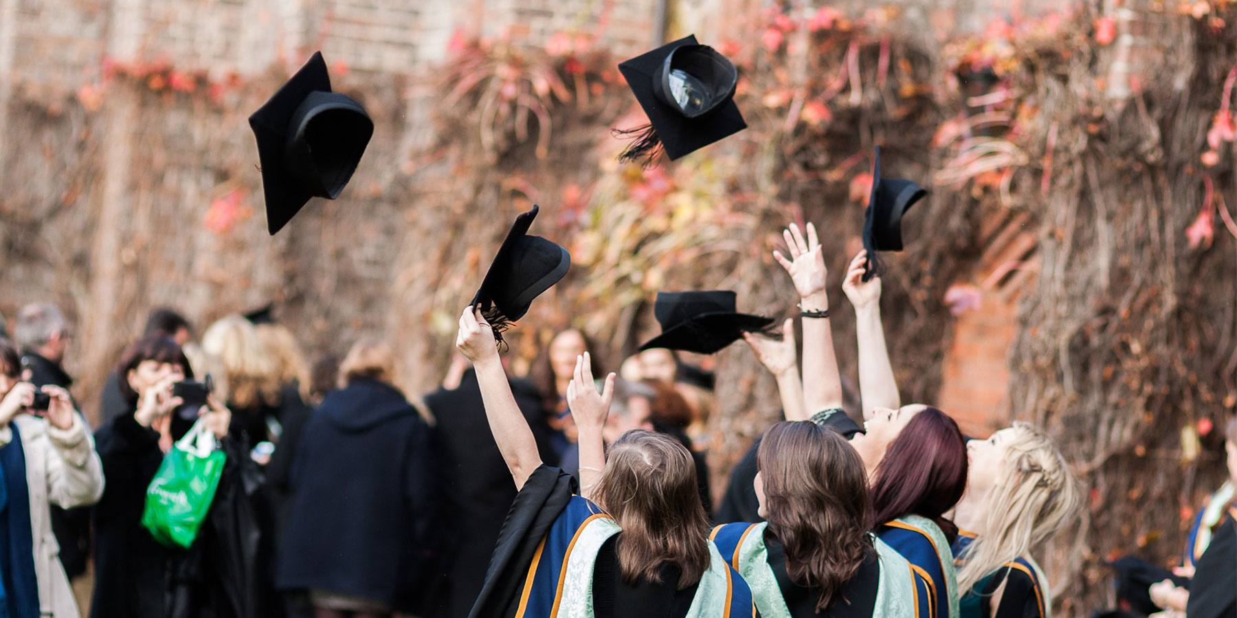 Graduands throwing their hats in the Quad