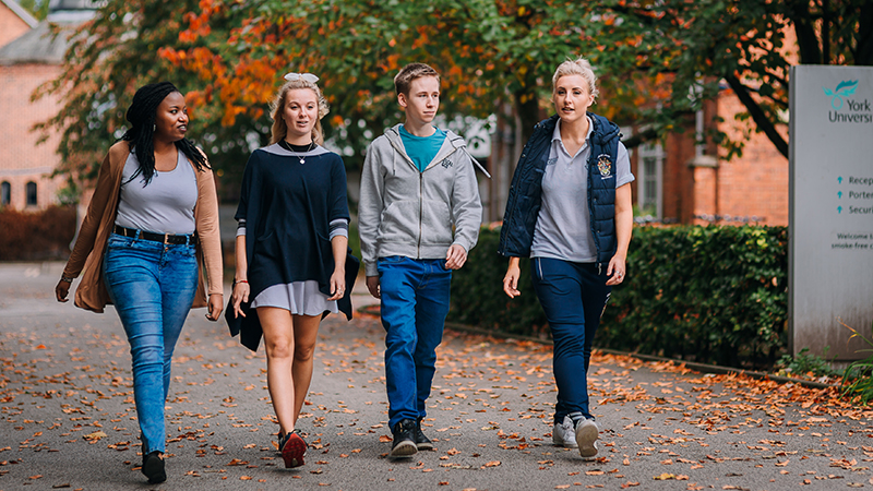 Students walking through campus in Autumn