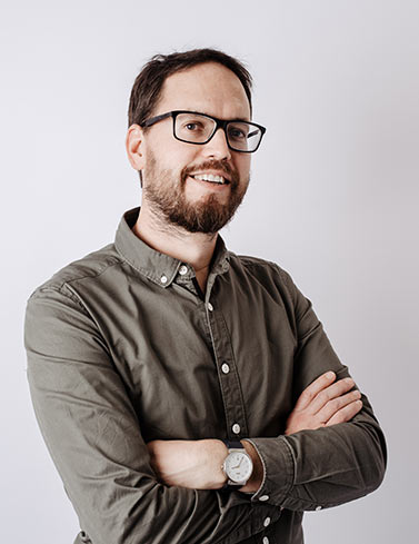Matthew Reason standing with arms folded