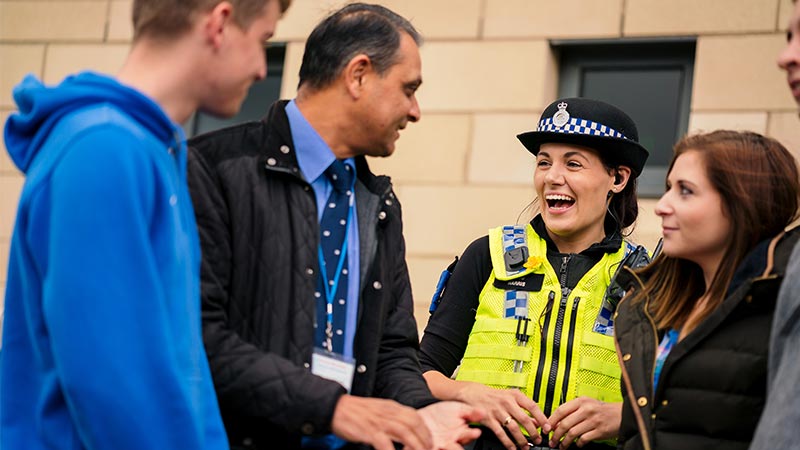 Students talking to Police Officer outside Fountains Lecture Theatre