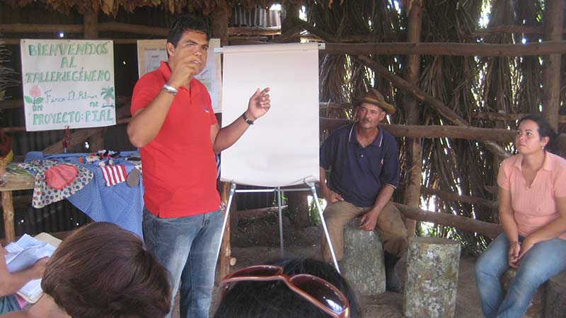 A man taking a class in a wooden hut