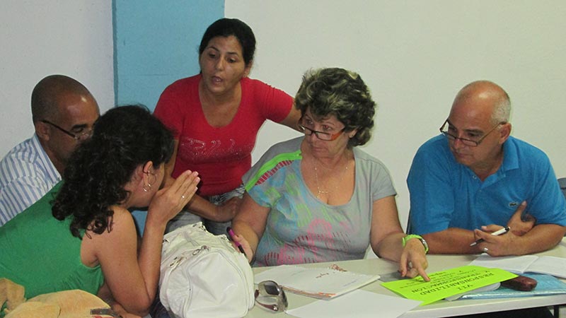 Multisectorial staff working around table in Cuba
