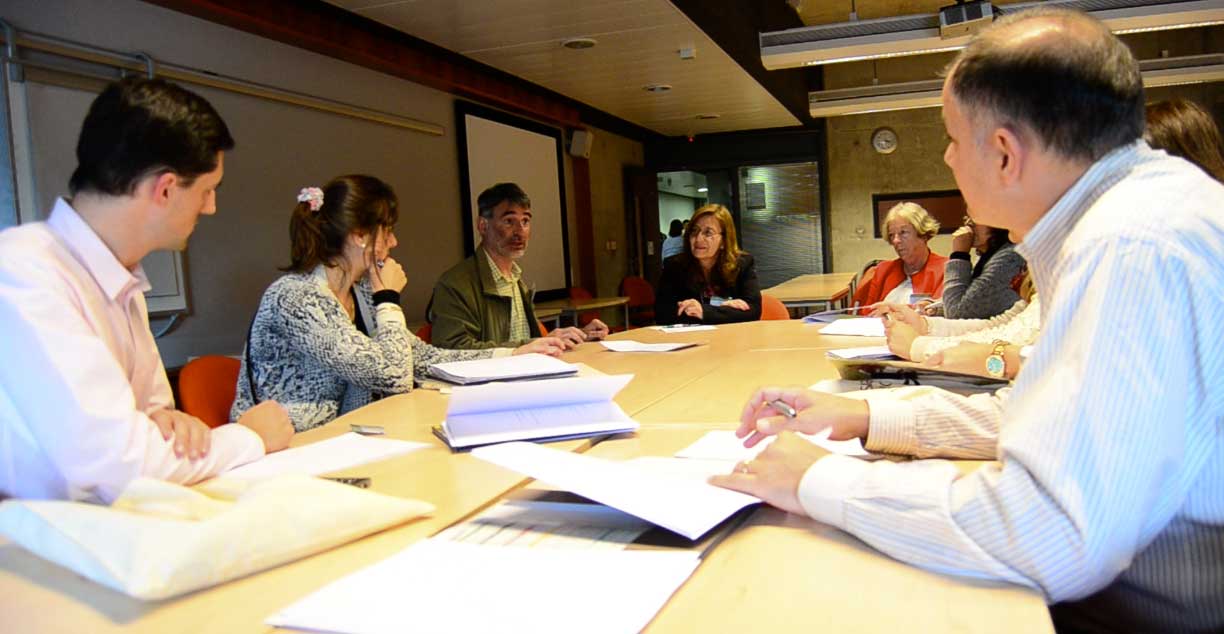 A group of people sitting around a table having a discussion