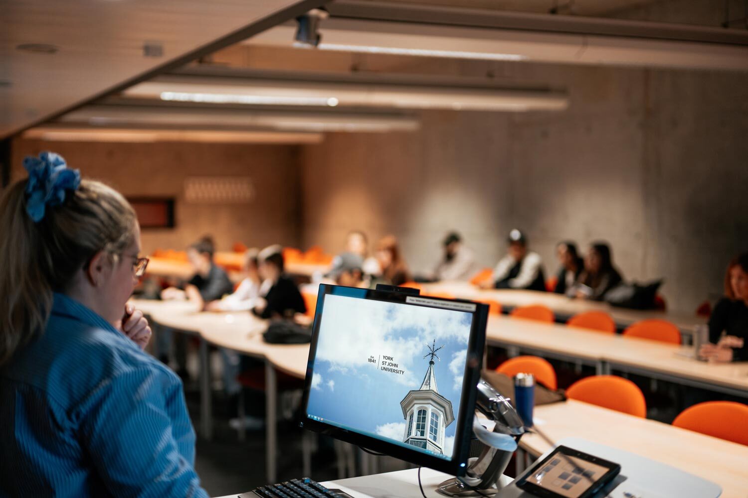 a lecture theatre of students being taught by a professor