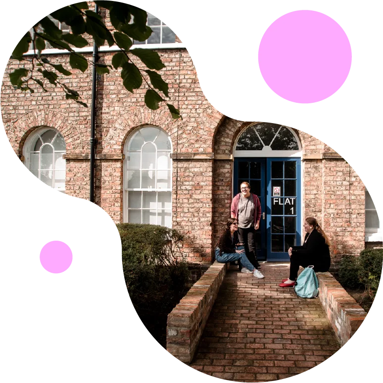 a brick building with people standing in a doorway